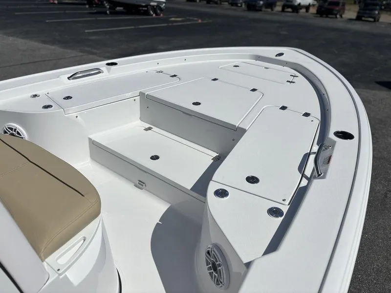 Slide: The Image of 2026 Sportsman Masters 227 Bay Boat with beige seating and spacious deck layout. - 28
