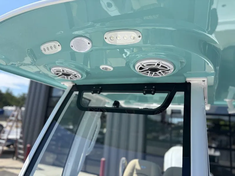 Slide: The Image of 2026 Sportsman Masters 227 Bay Boat interior with white seating and storage compartments. - 30