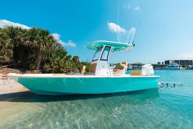 Slide: The Image of 2026 Sportsman Masters 227 Bay Boat on calm water, featuring spacious deck and storage compartments. - 37