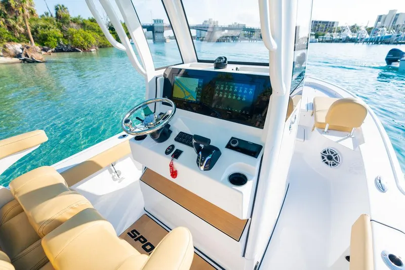 Slide: The Image of 2026 Sportsman Masters 227 Bay Boat cruising on a serene lake with lush forest backdrop. - 38