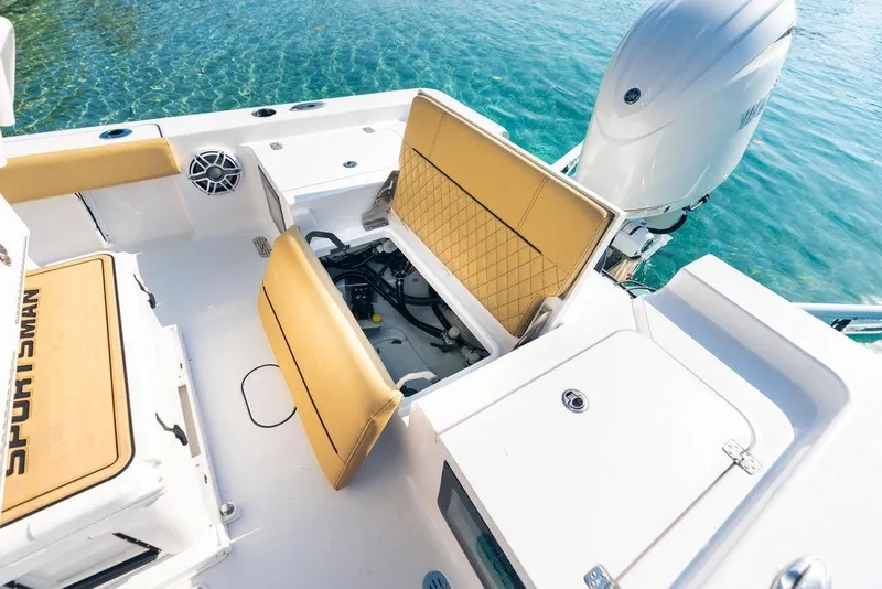 Slide: The Image of 2026 Sportsman Masters 227 Bay Boat interior with tan seating and storage compartments. - 47