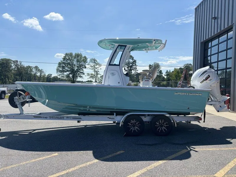 Slide: The Image of 2026 Sportsman Masters 227 Bay Boat on trailer, parked outdoors near a building. - 6
