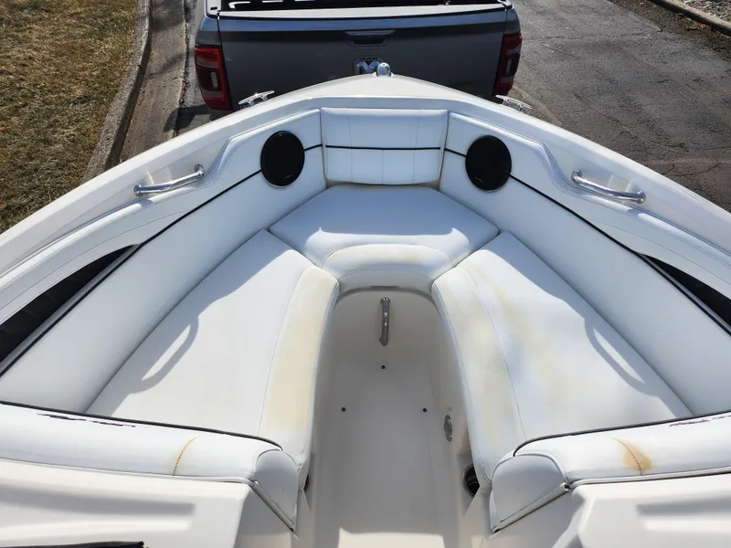 Slide: The Image of 2014 Sea Ray 210 SLX boat interior with white seating and speakers. - 16
