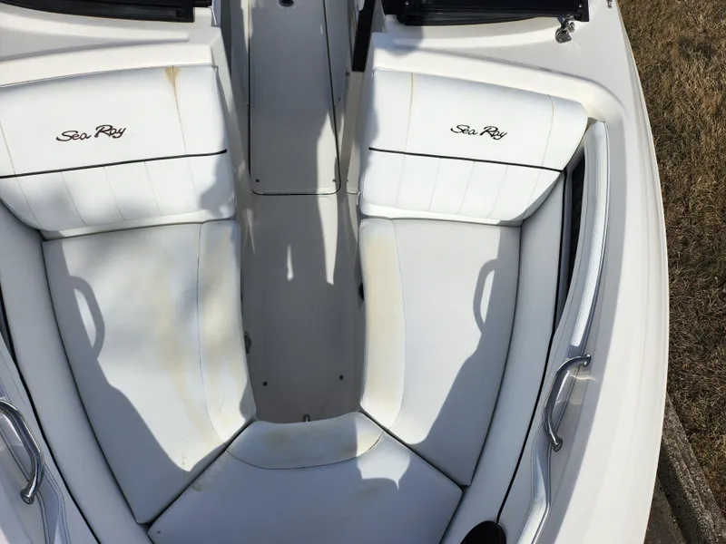 Slide: The Image of 2014 Sea Ray 210 SLX boat interior with white seating and logo. - 18