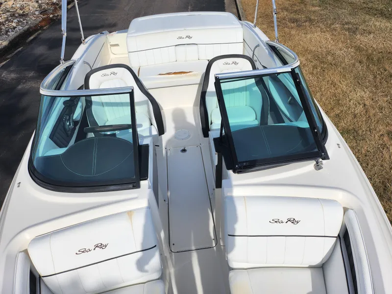 Slide: The Image of 2014 Sea Ray 210 SLX boat interior with white seating and open windshield. - 19