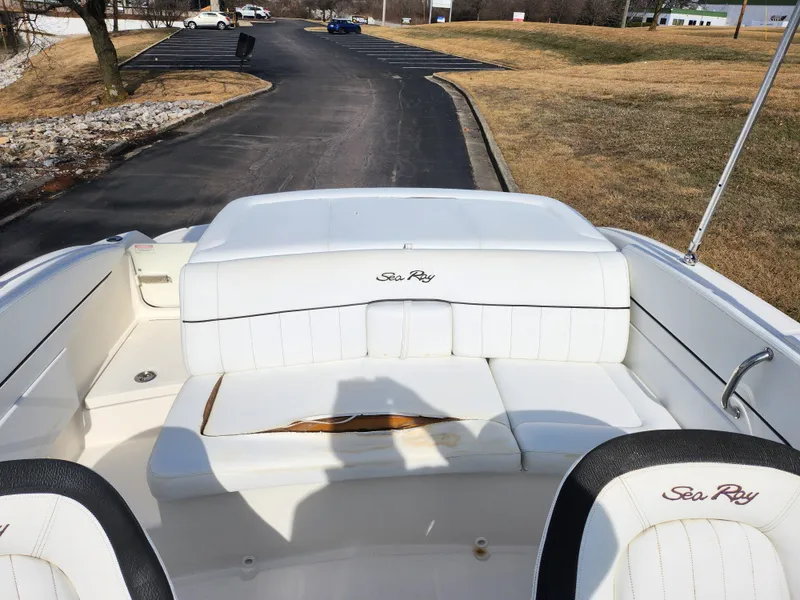 Slide: The Image of 2014 Sea Ray 210 SLX boat interior with white seating and visible wear. - 21