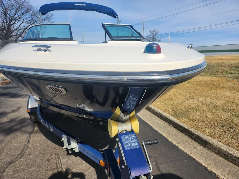 Slide: The Image of 2014 Sea Ray 210 SLX boat on trailer, parked outdoors, sunny day. - 6