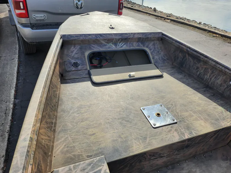 Slide: The Image of 2019 G3 Gator Tough 15 DK boat on trailer, open storage compartment visible. - 12