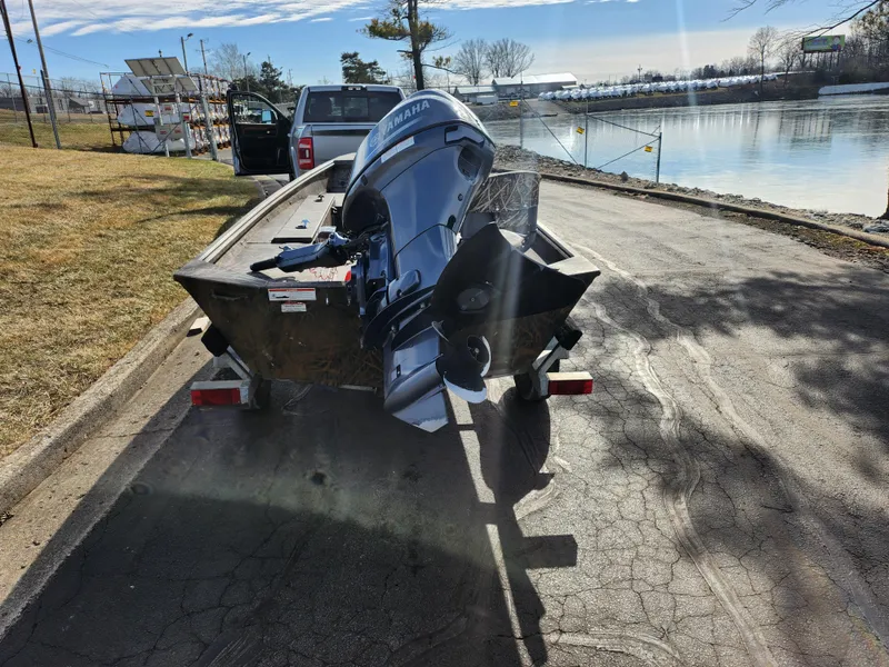 Slide: The Image of 2019 G3 Gator Tough 15 DK boat on trailer by a riverside. - 2