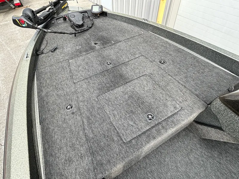 Slide: The Image of 1997 Ranger 481VS boat deck with carpeted surface and storage compartments. - 2