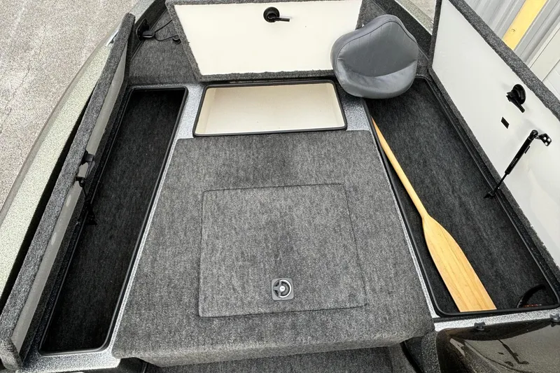 Slide: The Image of 1997 Ranger 481VS boat interior with storage compartments and paddle. - 3