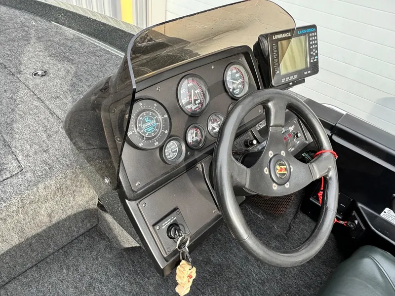 Slide: The Image of 1997 Ranger 481VS boat dashboard with steering wheel and gauges. - 5