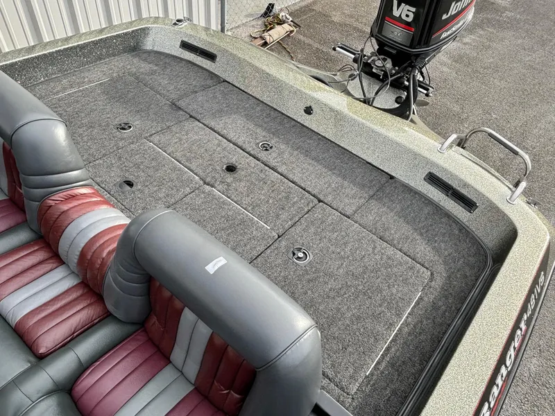 Slide: The Image of 1997 Ranger 481VS boat interior with gray and red seating, featuring a Johnson V6 outboard motor. - 6