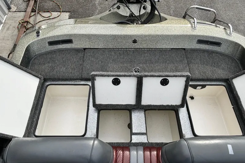 Slide: The Image of 1997 Ranger 481VS boat interior with open storage compartments and seating. - 7