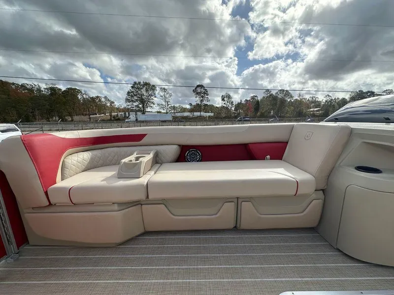 Slide: The Image of Luxurious seating on 2025 Godfrey SWEETWATER 2286 SB pontoon boat under cloudy sky. - 5