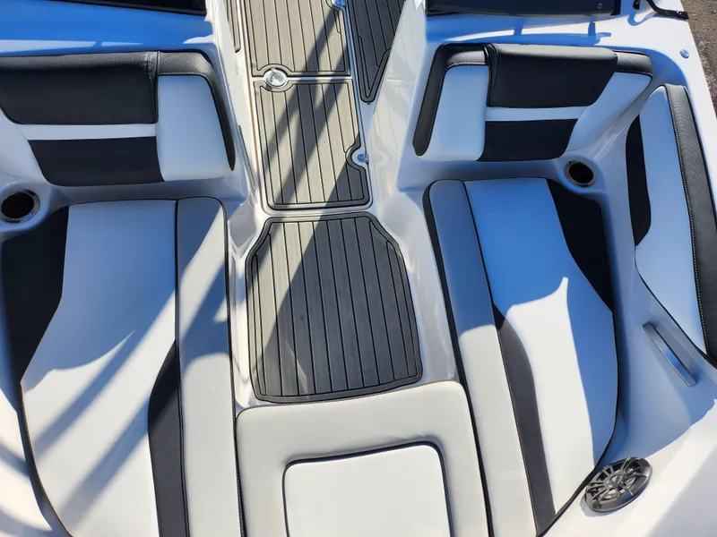 Slide: The Image of 2021 Yamaha Boats AR195 interior seating with sleek black and white design. - 17
