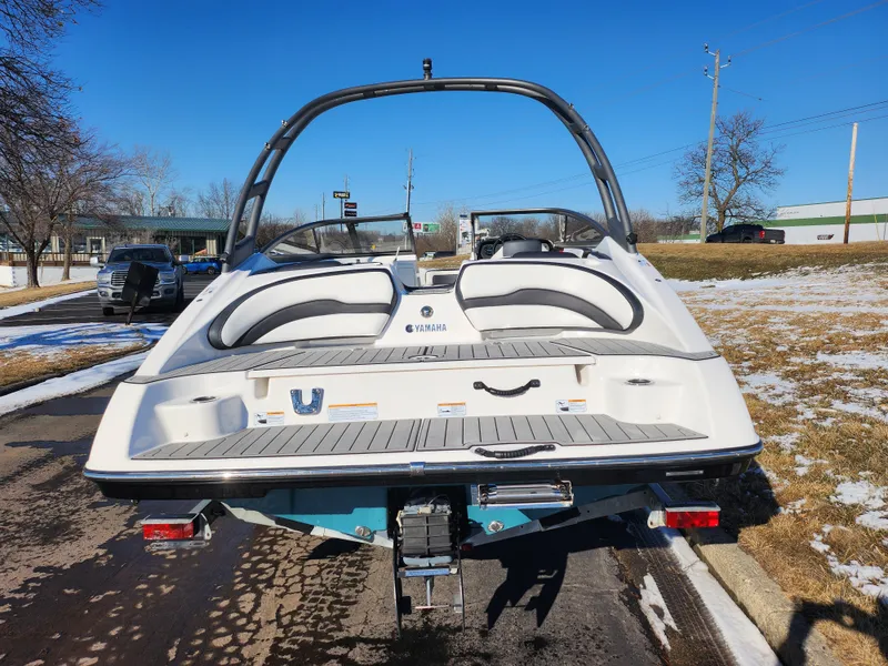 Slide: The Image of 2021 Yamaha Boats AR195 on trailer, rear view, parked on a sunny day. - 2