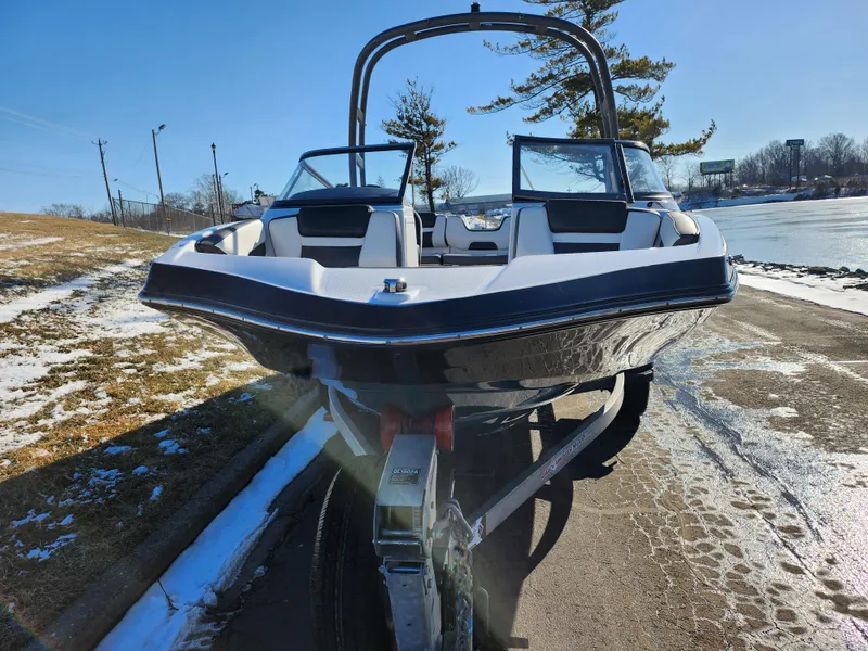 Slide: The Image of 2021 Yamaha Boats AR195 on trailer, parked near snowy lakeside. - 6