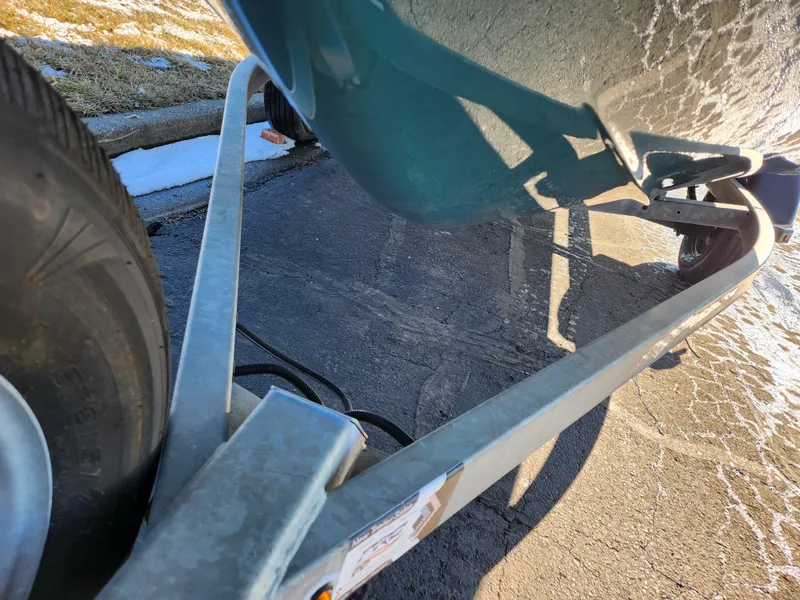 Slide: The Image of Close-up of a 2021 Yamaha Boats AR195 trailer and tire on pavement. - 7