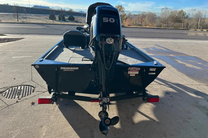 Slide: The Image of 2024 Tracker Bass Tracker Classic XL boat with 50 HP engine, parked outdoors. - 3