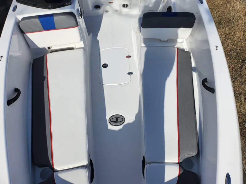 Slide: The Image of 2023 Tahoe T18 boat interior with white and gray seating, red accents. - 17