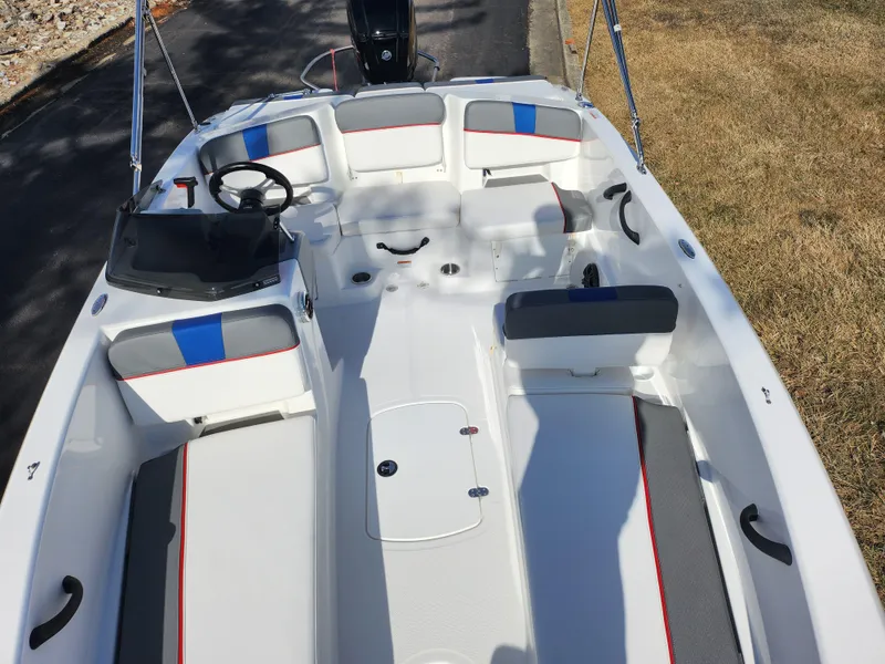 Slide: The Image of 2023 Tahoe T18 boat interior with seating and steering wheel, featuring modern design elements. - 18