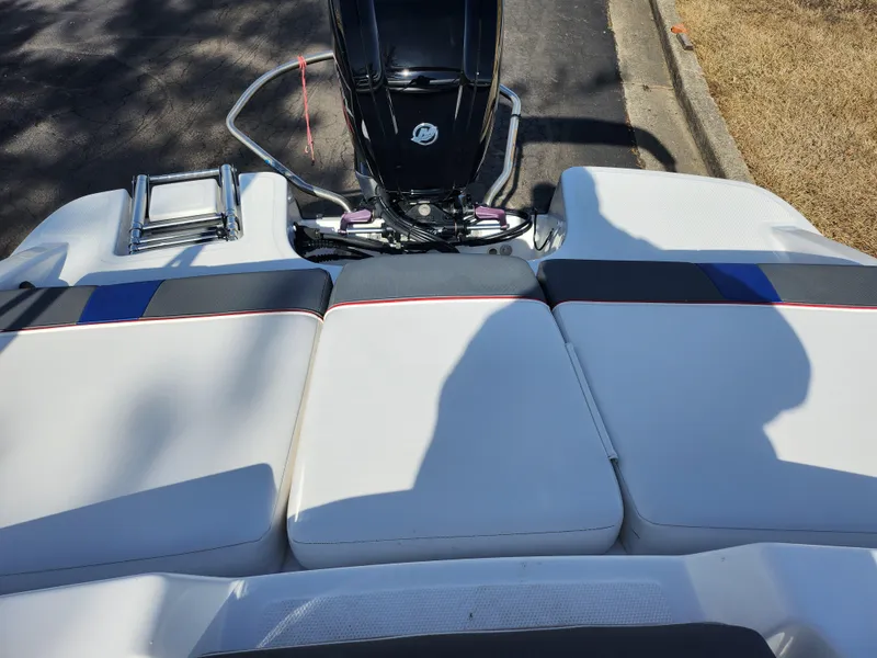 Slide: The Image of 2023 Tahoe T18 boat with cushioned seating and outboard motor. - 21