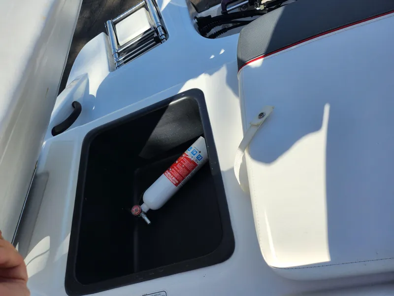 Slide: The Image of 2023 Tahoe T18 boat interior with fire extinguisher in storage compartment. - 23
