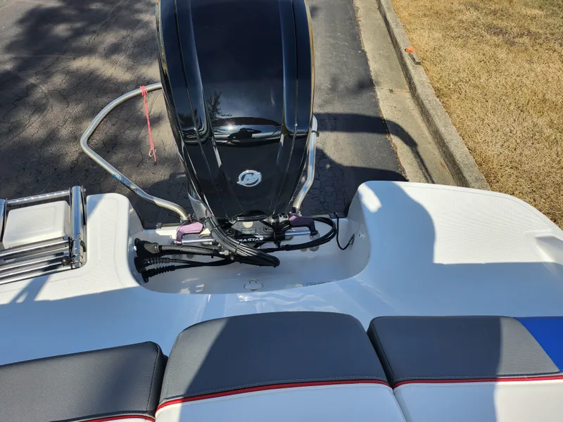 Slide: The Image of 2023 Tahoe T18 boat engine and seating area, parked on a sunny day. - 24
