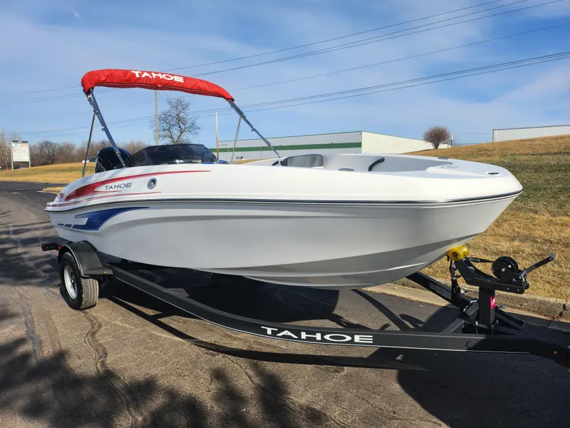 Slide: The Image of 2023 Tahoe T18 boat with red canopy on trailer, parked outdoors. - 5