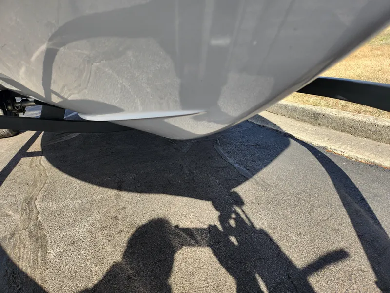 Slide: The Image of 2023 Tahoe T18 boat hull on trailer, shadow on pavement. - 7