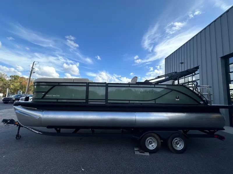 The Image of 2025 Godfrey Sweetwater 2286 SFLC pontoon boat on trailer, parked outdoors. - 1