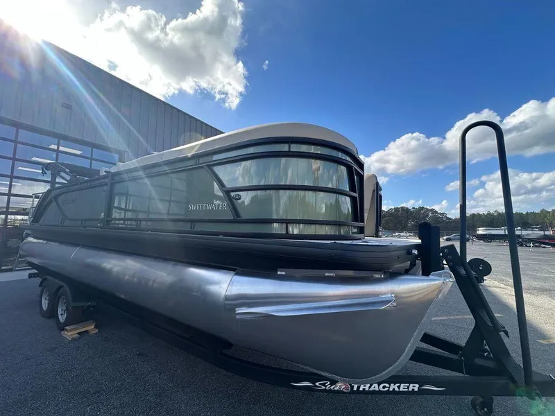 Slide: The Image of 2025 Godfrey Sweetwater 2286 SFLC pontoon boat on trailer under blue sky. - 4