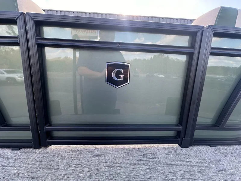 Slide: The Image of 2025 Godfrey Sweetwater 2286 SFLC boat with "G" logo on glass panel. - 5