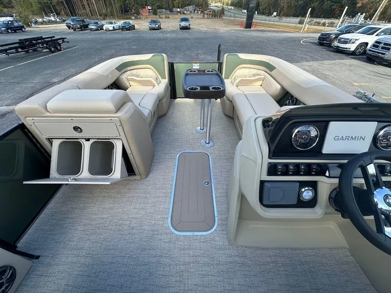 Slide: The Image of 2025 Godfrey Sweetwater 2286 SFLC boat interior with seating, table, and Garmin navigation system. - 8