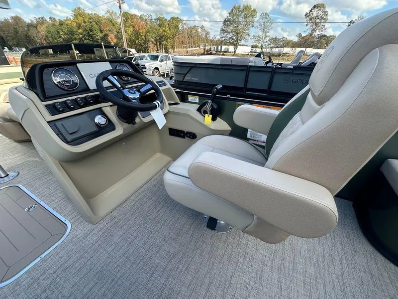 Slide: The Image of 2025 Godfrey Sweetwater 2286 SFLC boat interior with steering wheel and captain's chair. - 9