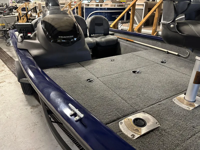 Slide: The Image of 2019 Tracker Pro Team 175 TF boat interior with seating and carpeted deck. - 12
