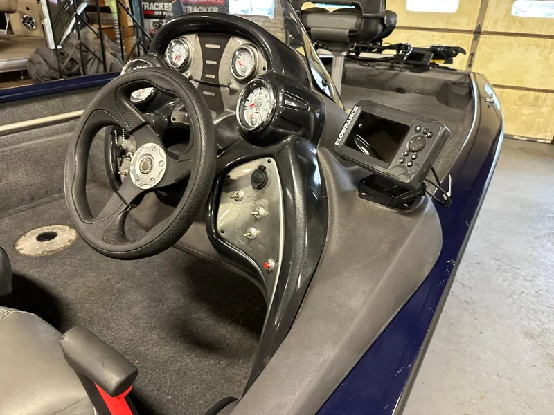 Slide: The Image of 2019 Tracker Pro Team 175 TF boat dashboard with steering wheel and gauges. - 14
