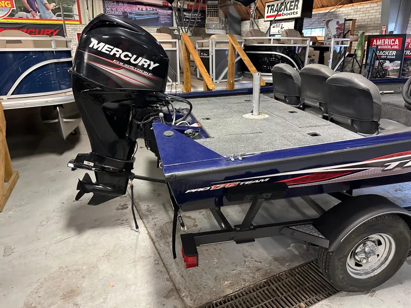 Slide: The Image of 2019 Tracker Pro Team 175 TF boat with Mercury outboard motor in showroom. - 3