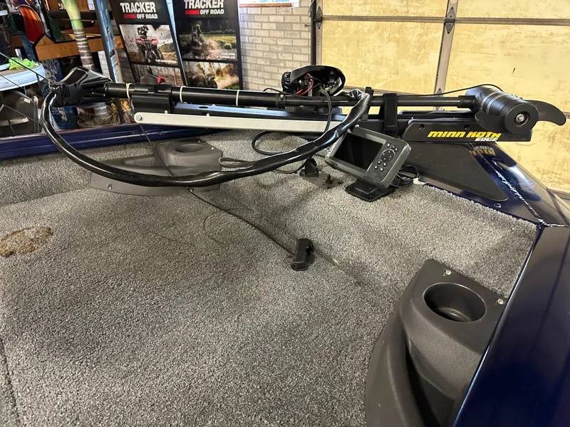 Slide: The Image of 2019 Tracker Pro Team 175 TF boat with Minn Kota trolling motor on carpeted deck. - 4