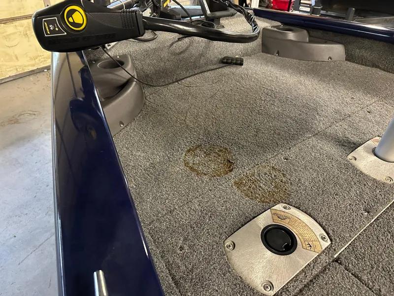 Slide: The Image of 2019 Tracker Pro Team 175 TF boat interior with carpet stains and control panel. - 7