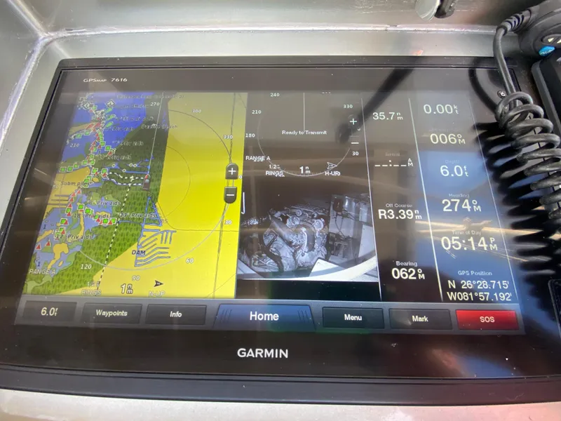 Slide: The Image of Garmin navigation display on 1995 Mares 58 Power Cat, showing maps and vessel data. - 10