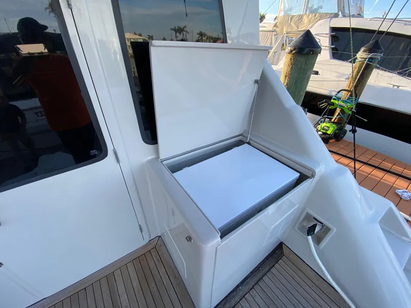 Slide: The Image of Mares 58 Power Cat 1995 boat with open storage compartment on deck. - 24