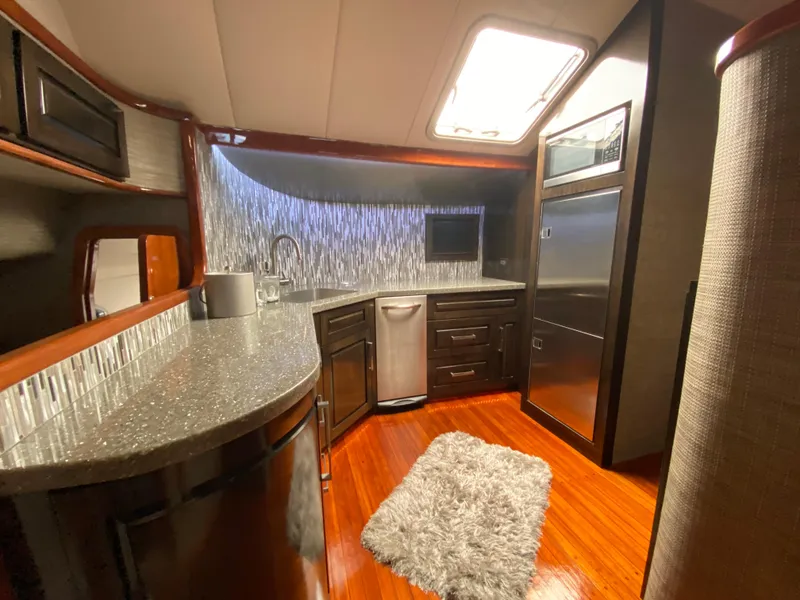 Slide: The Image of Luxurious kitchen interior of 1995 Mares 58 Power Cat with modern appliances and wood flooring. - 36