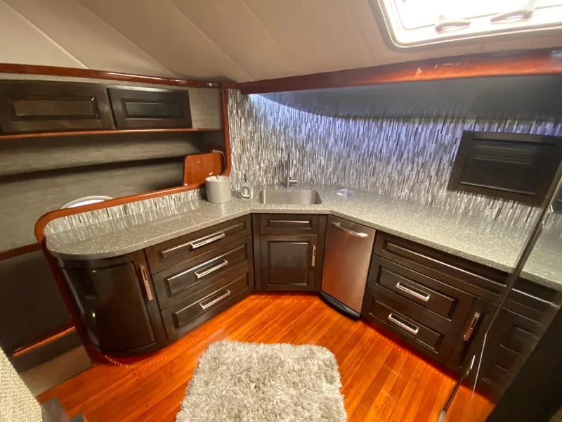 Slide: The Image of Luxurious kitchen interior of 1995 Mares 58 Power Cat yacht with modern cabinetry and wood flooring. - 37