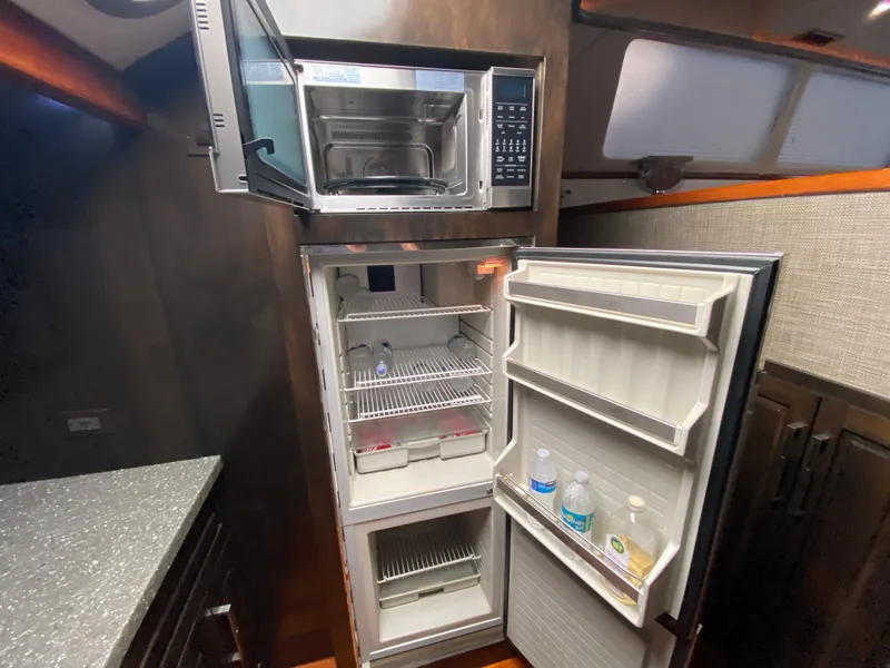 Slide: The Image of Microwave and open fridge inside 1995 Mares 58 Power Cat yacht kitchen. - 39