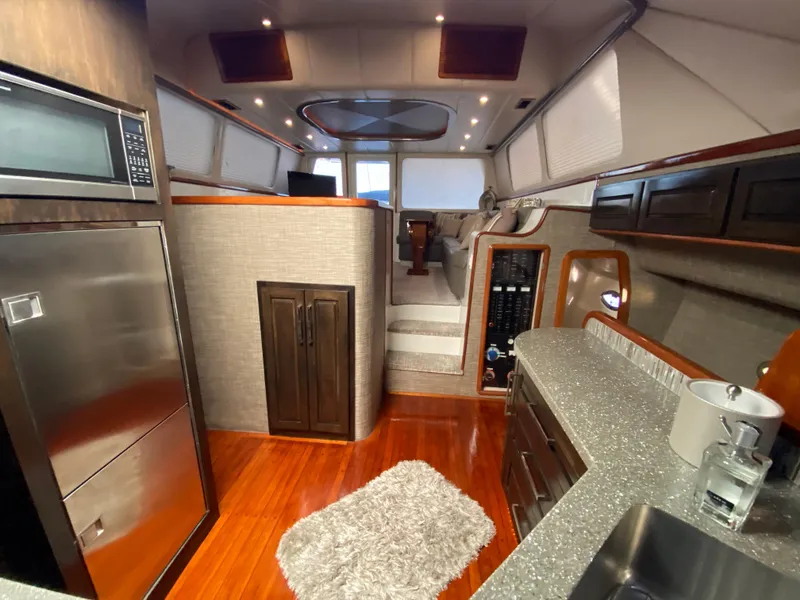 Slide: The Image of Luxurious interior of a 1995 Mares 58 Power Cat yacht with modern kitchen amenities. - 40