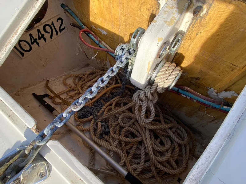 Slide: The Image of Anchor locker of 1995 Mares 58 Power Cat with ropes and chain. - 6