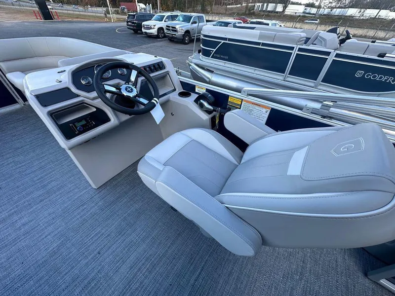 Slide: The Image of 2025 Godfrey Xperience 2286 SFLX boat interior with steering wheel and seating. - 5