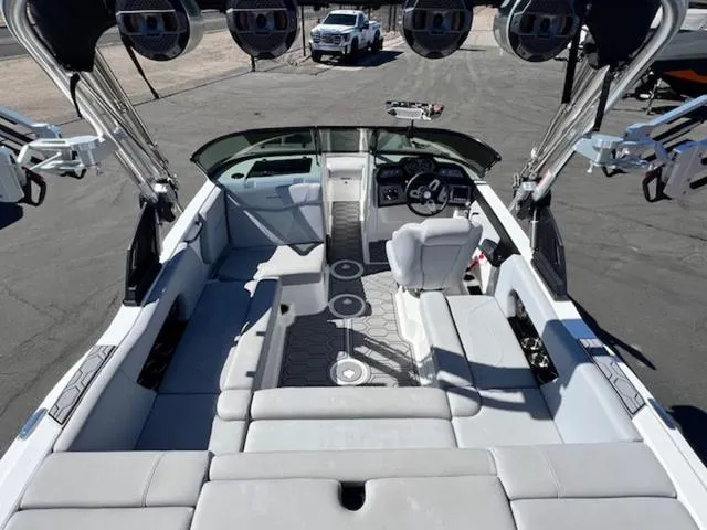 Slide: The Image of 2022 MasterCraft NXT20 boat interior with seating, steering wheel, and speakers. - 10